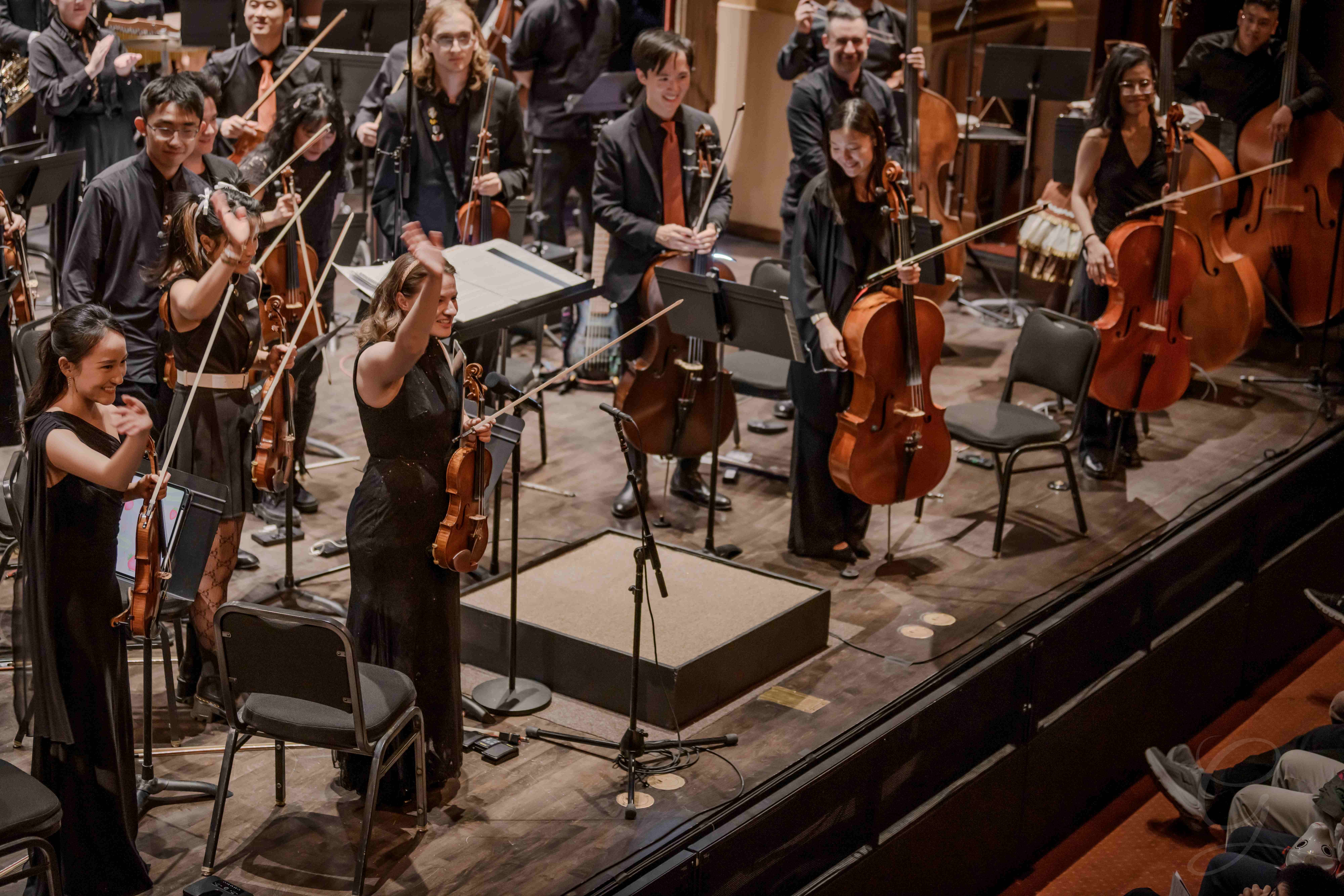Overhead view of the GG Orchestra taking a bow with strings raised
