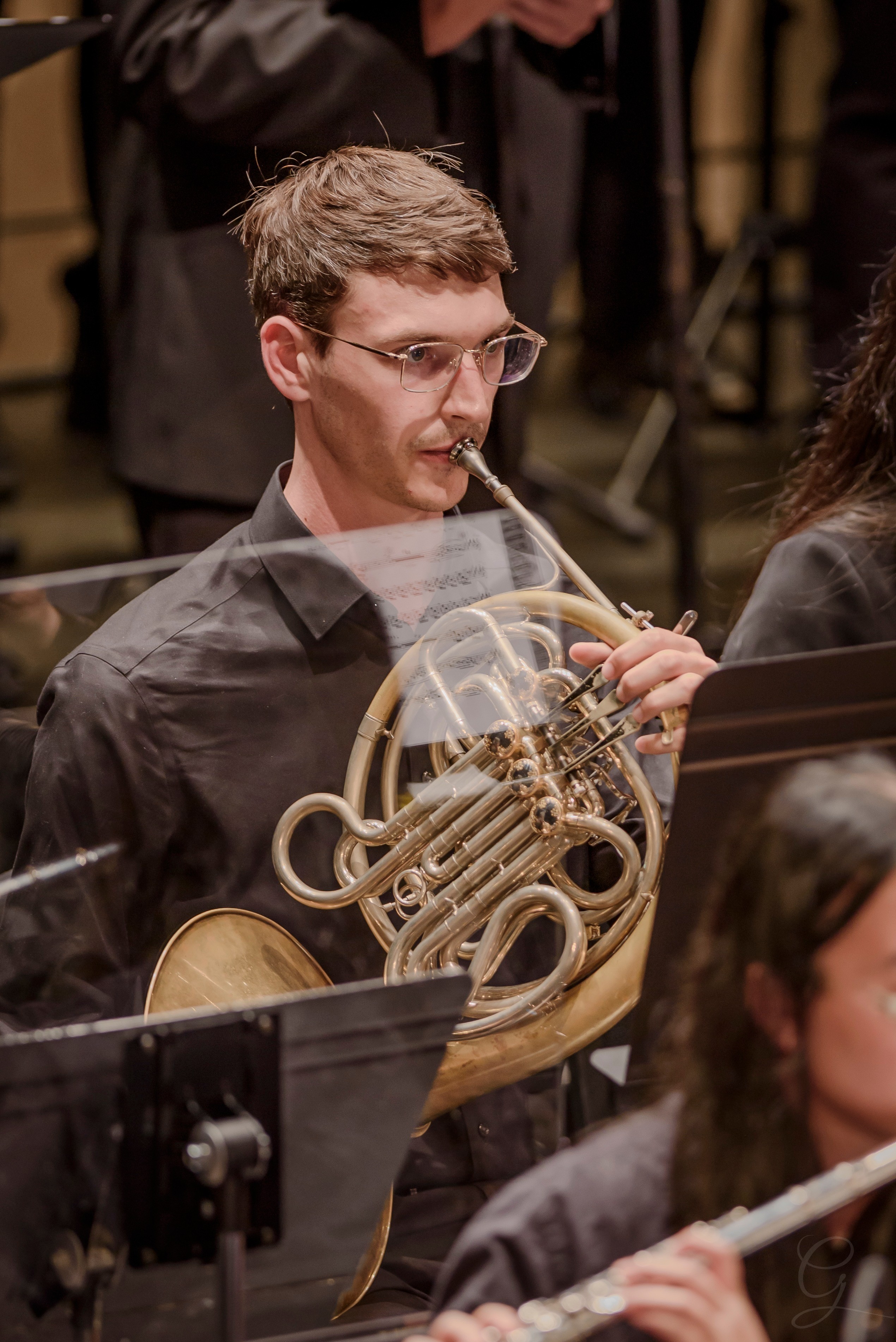 French horn player performing during a GG Orchestra concert
