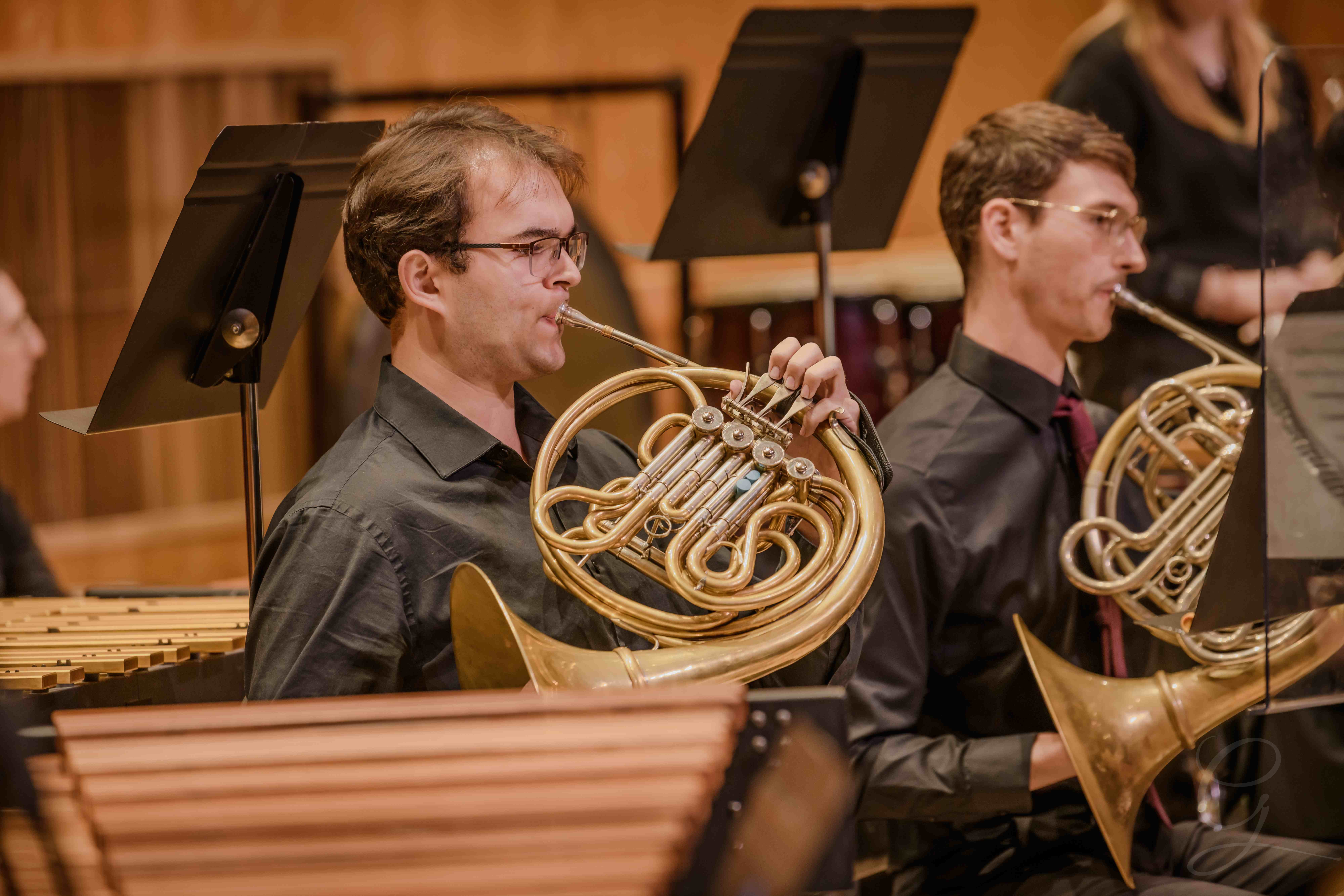 French horn players performing during a GG Orchestra concert