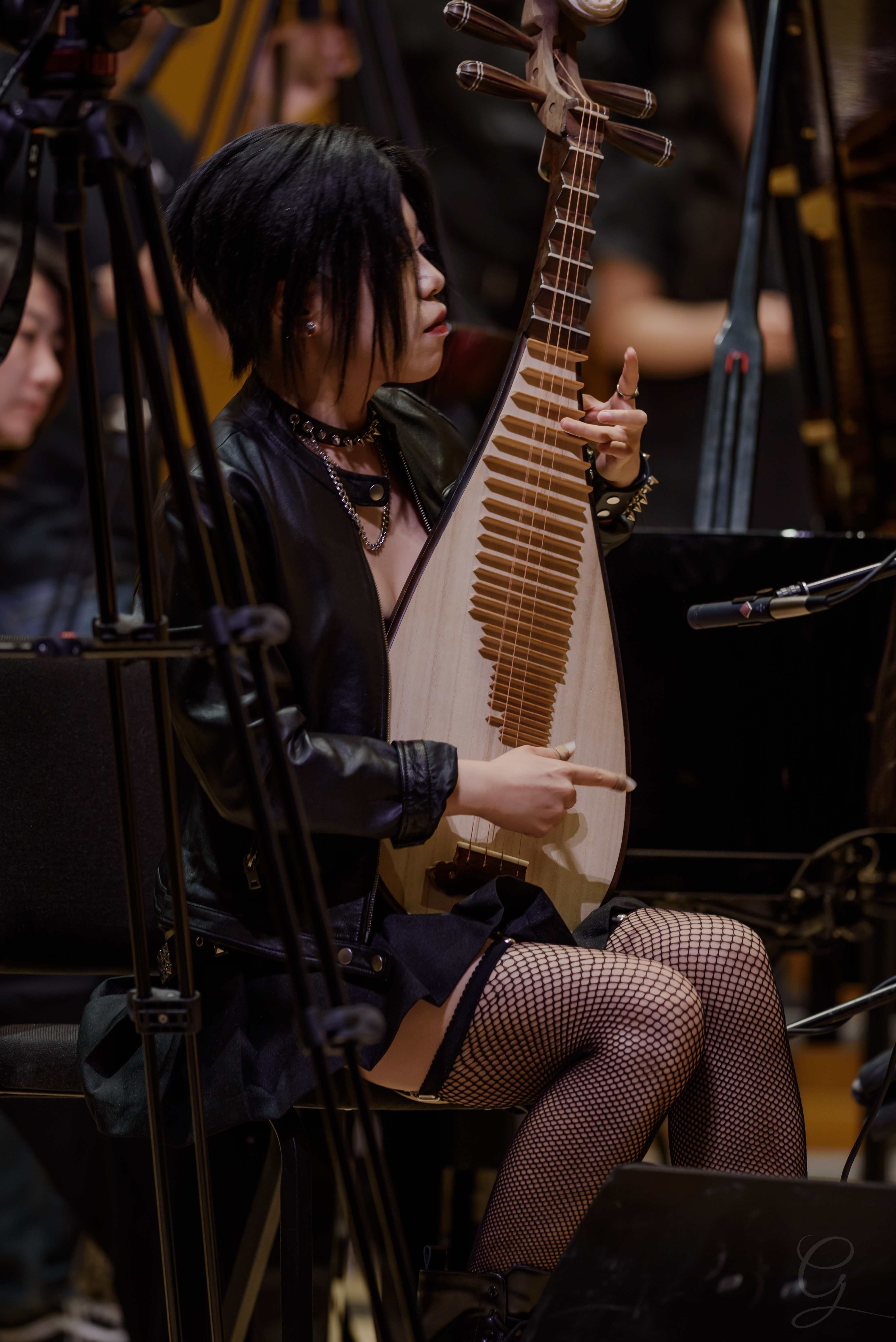 Pipa player performing traditional Chinese music with the ensemble